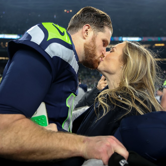 Sam Darnold and Katie Hoofnagle kiss after the Seattle Seahawks won the NFC championship game.